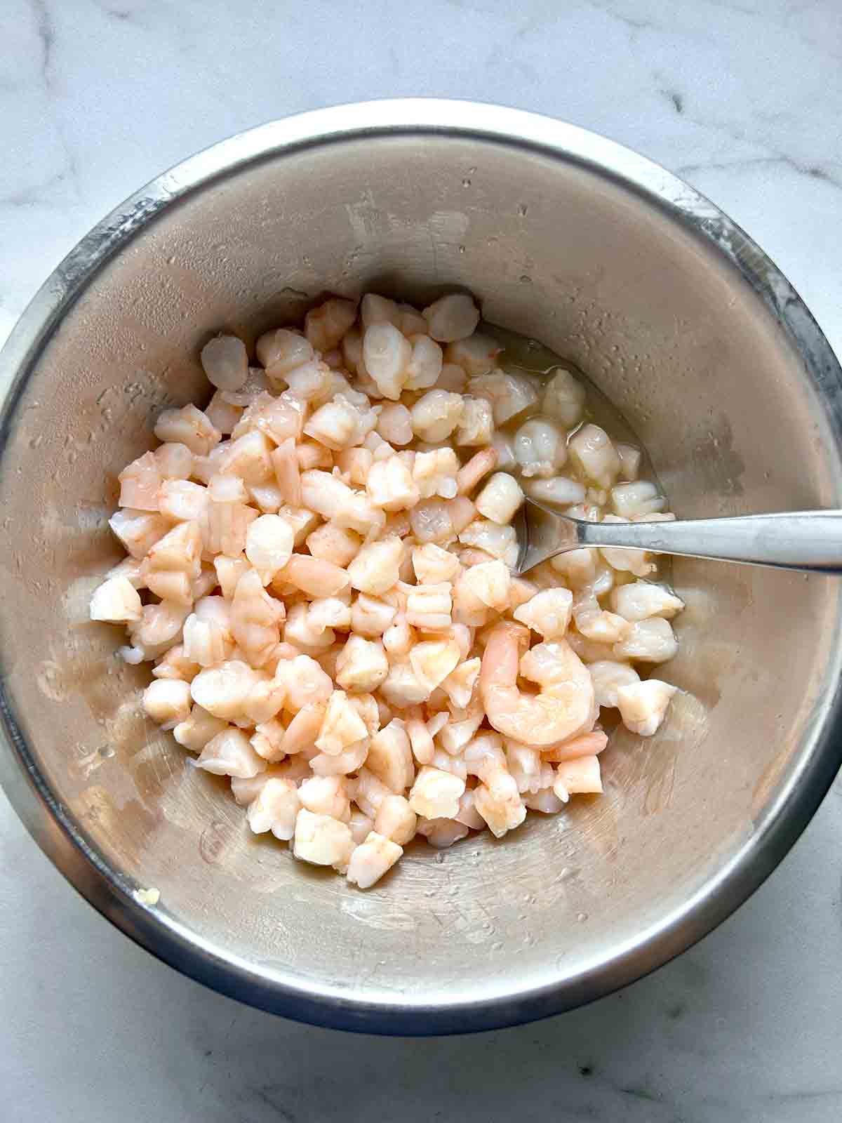 shrimp marinating in lemon and lime juice.