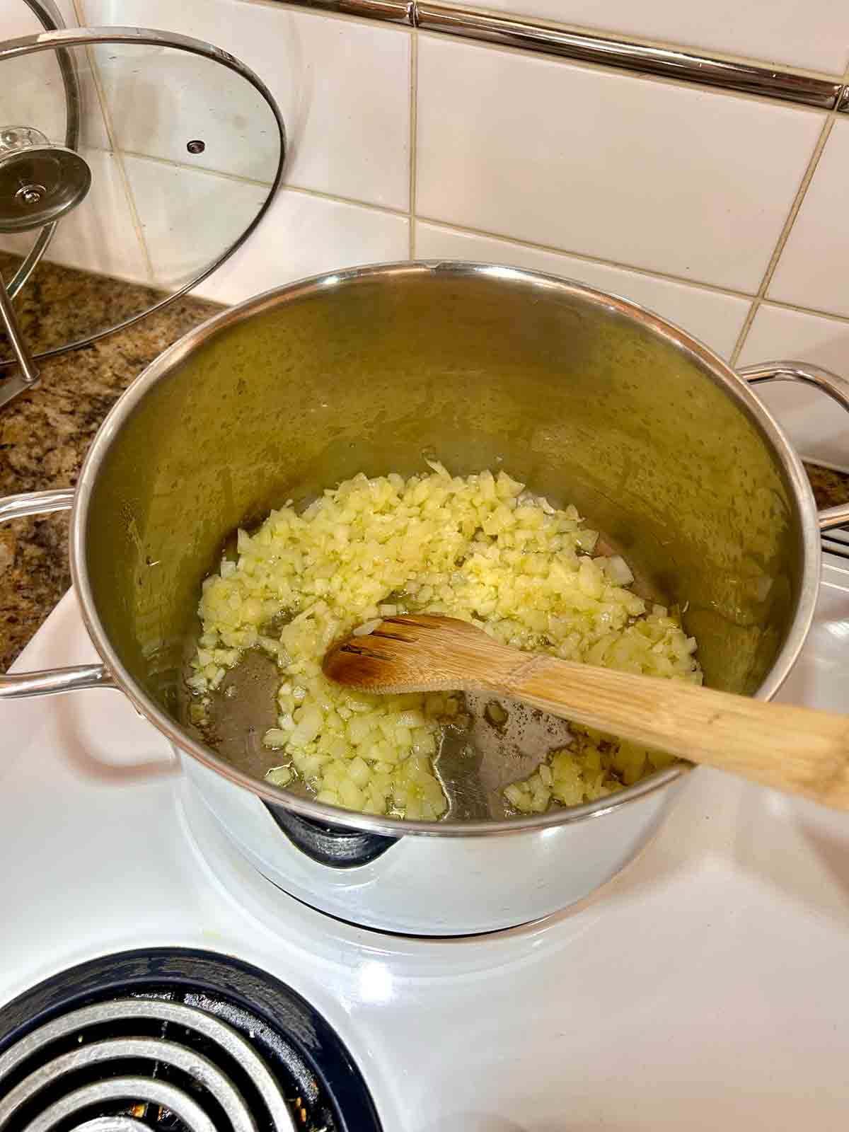 onions and garlic being sautéed in pot.