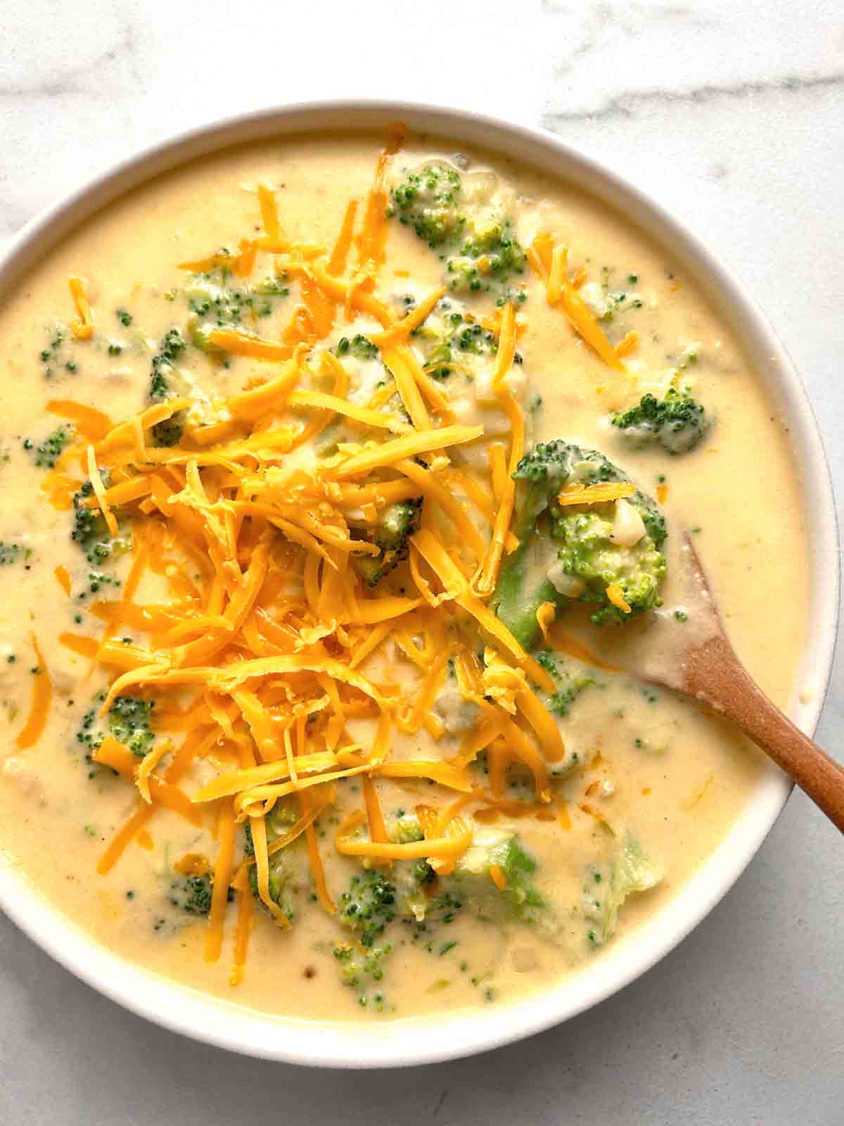overhead shot of broccoli cheddar soup in bowl.