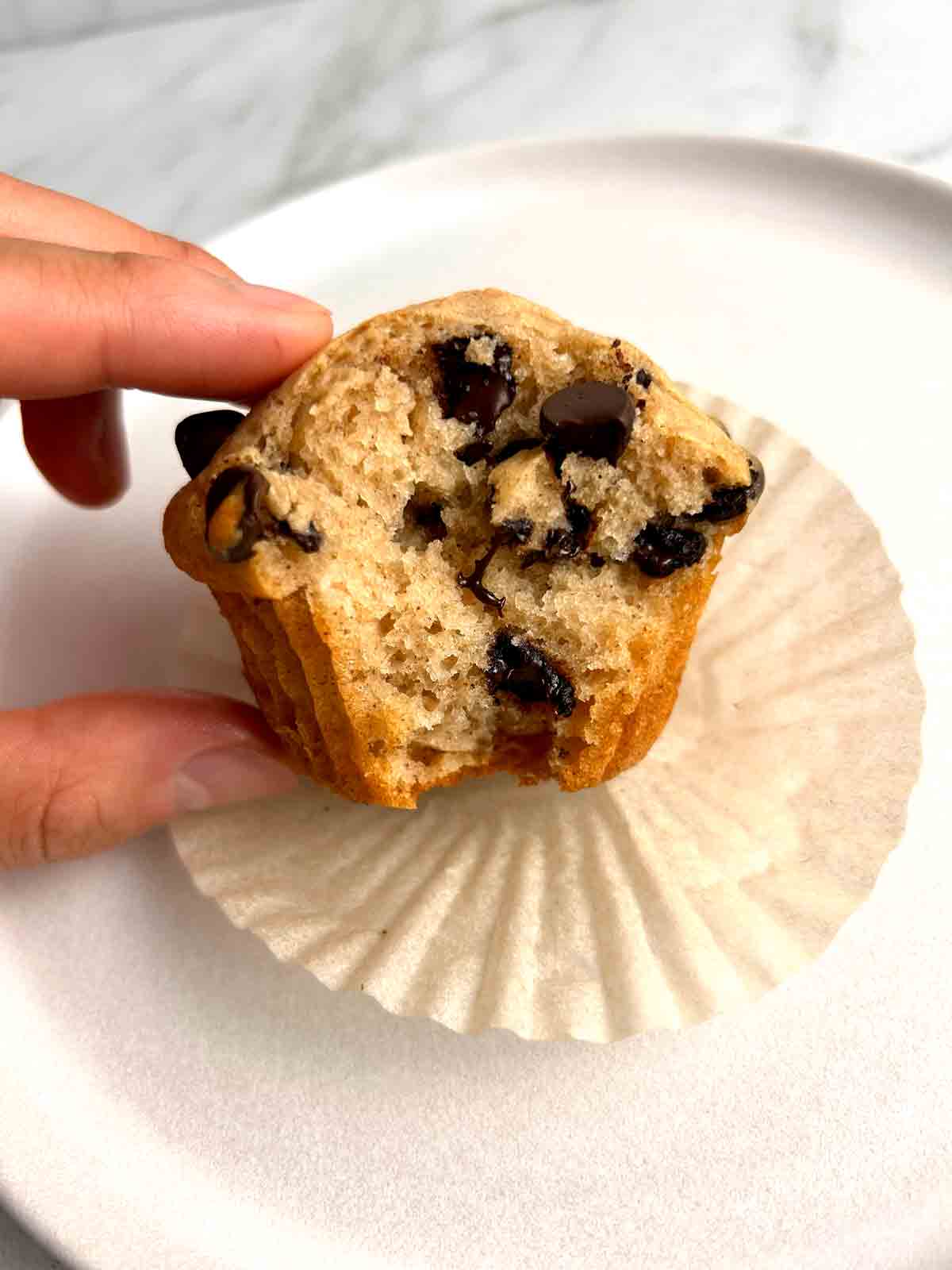 chocolate chip muffin with bite taken out of it.