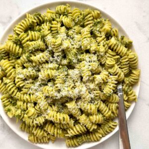 plate of pesto pasta with extra Parmesan cheese grated on top.