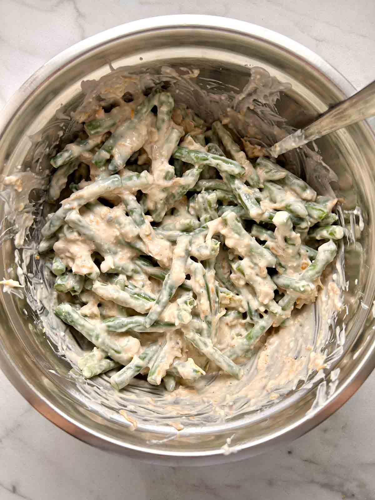green beans mixed with other ingredients in bowl.