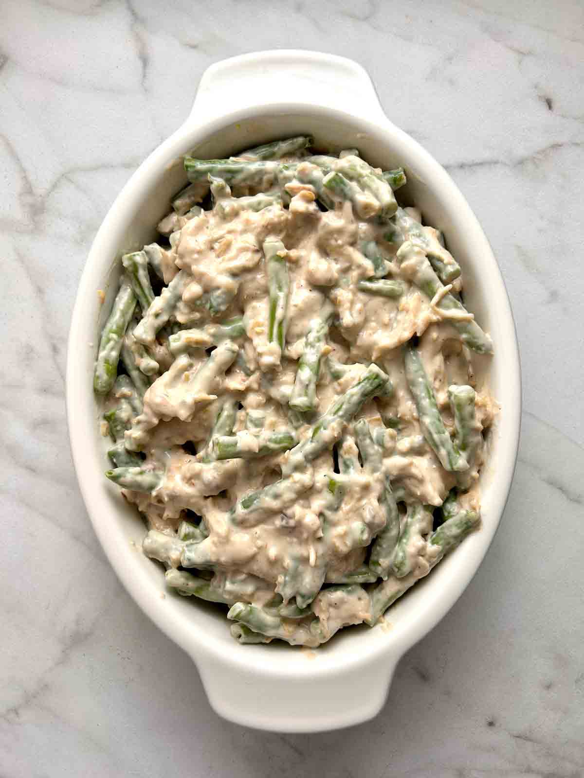 green bean filling spread into baking dish.
