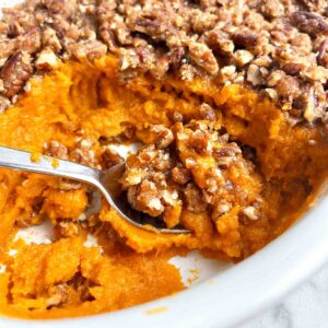 sweet potato casserole in baking dish with portion scooped out.
