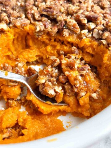 sweet potato casserole in baking dish with portion scooped out.