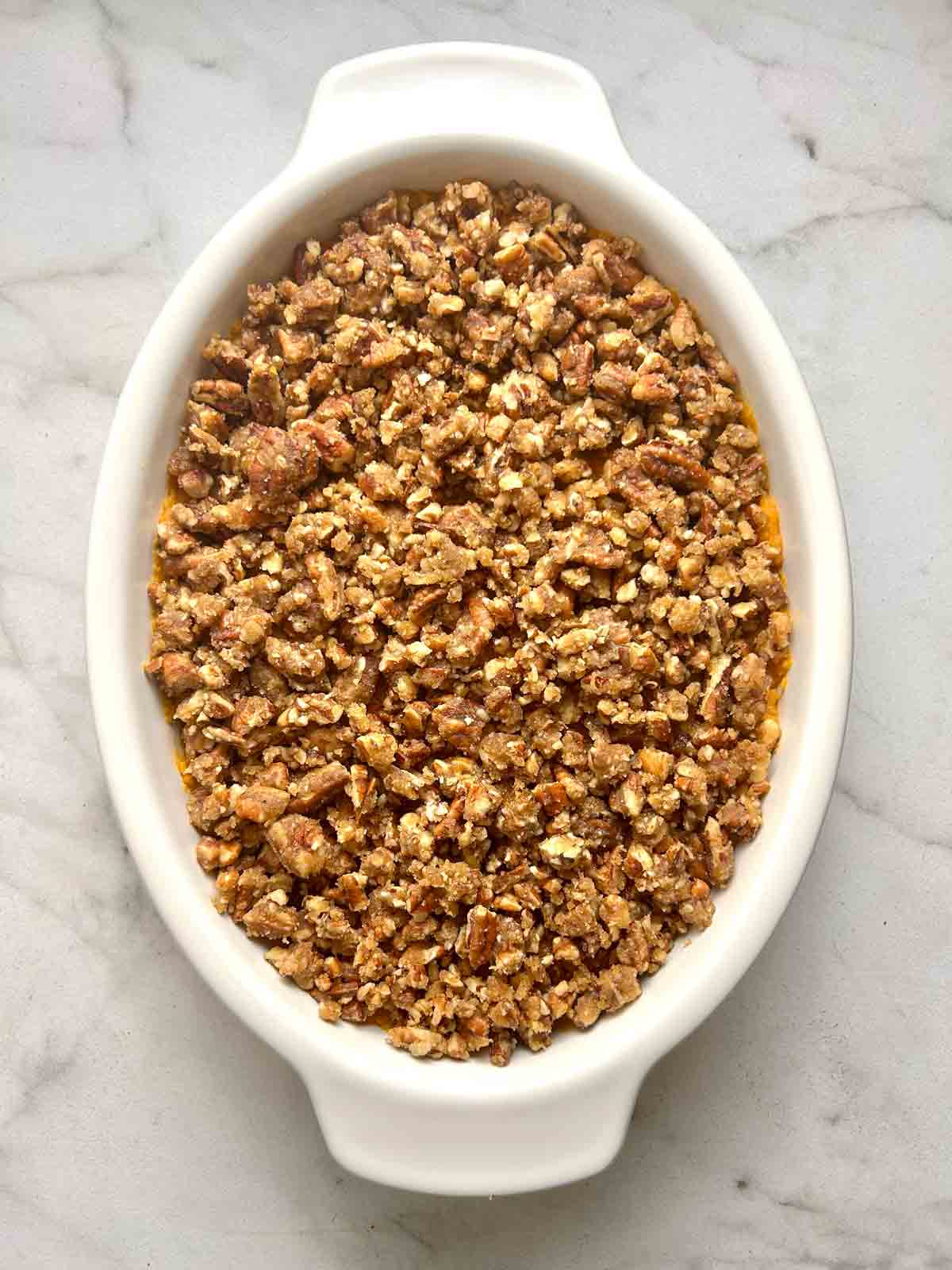 pecan streusel sprinkled on top of sweet potatoes.