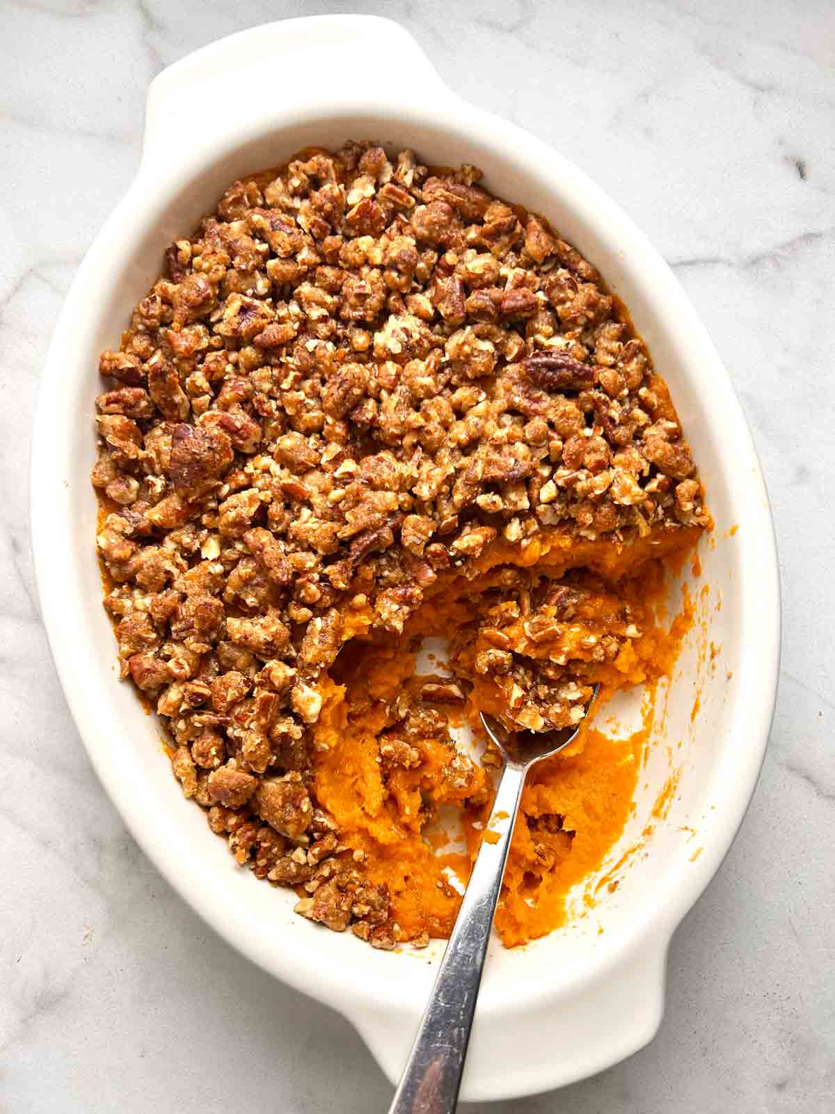 sweet potato casserole in baking dish with portion scooped out.