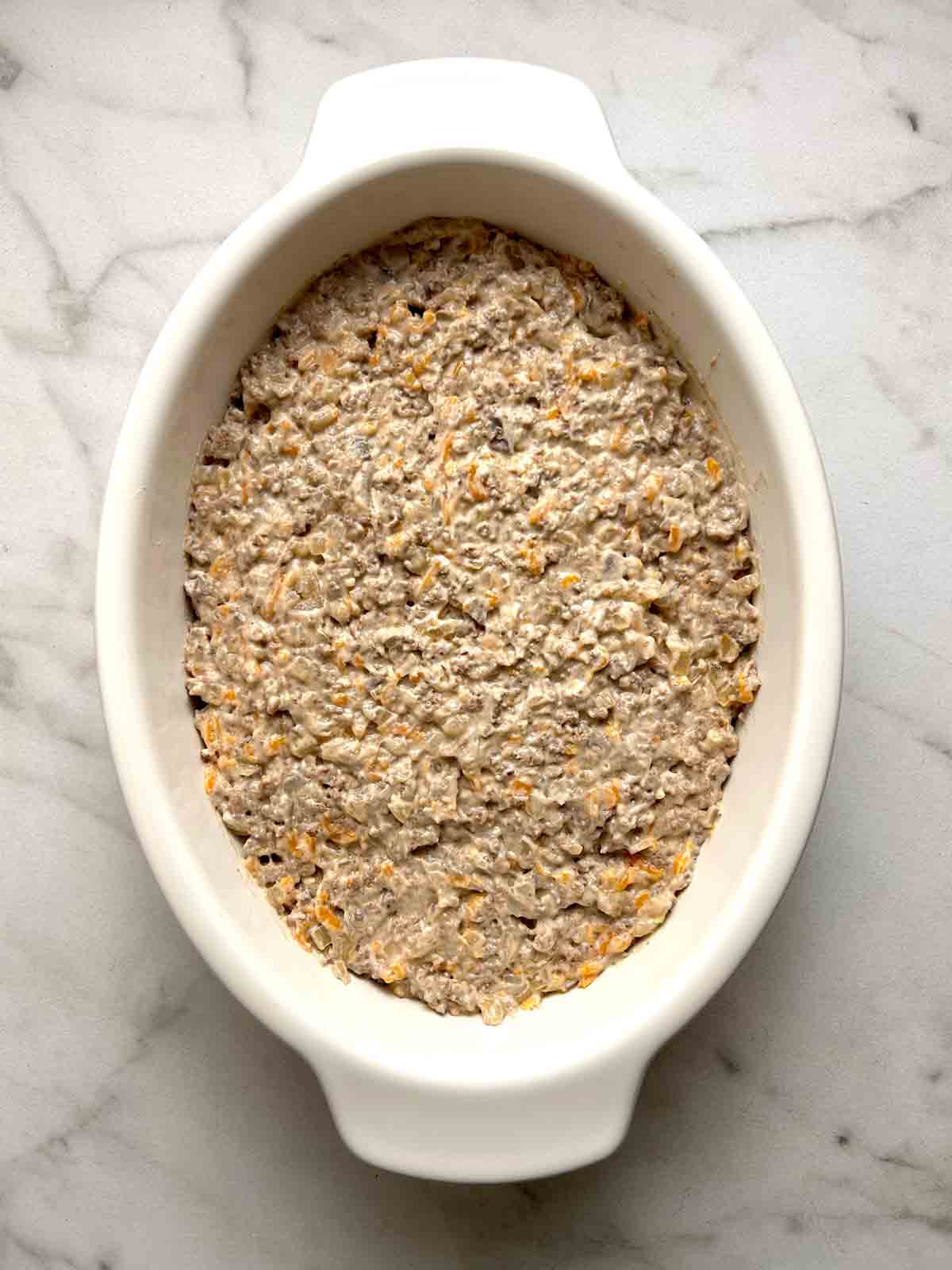 ground beef mixture spread into casserole dish.
