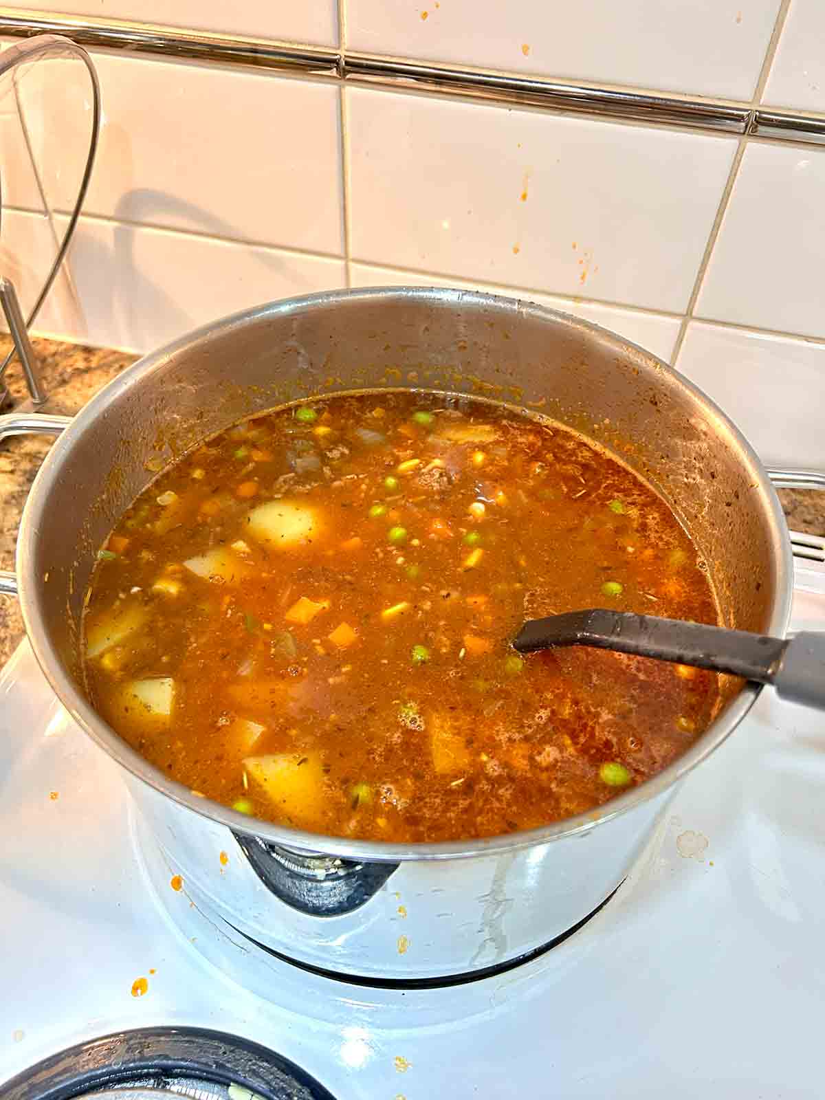 potatoes and mixed vegetables added to soup.