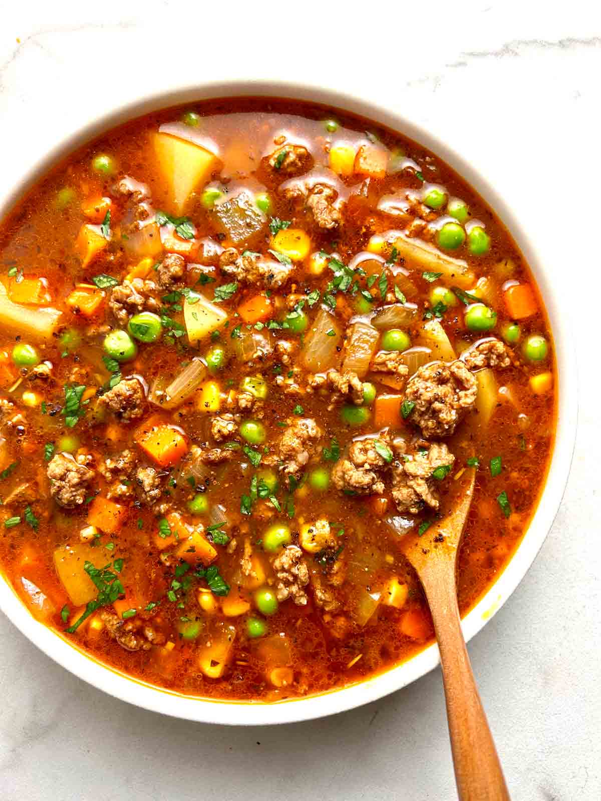 bowl of hamburger soup with spoon in it.