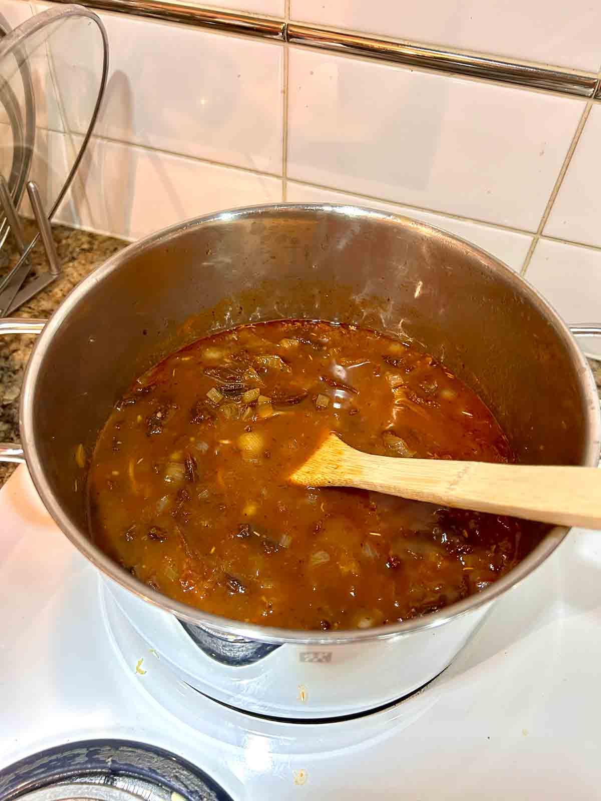 broth, tomato paste, and pasta added to pot.