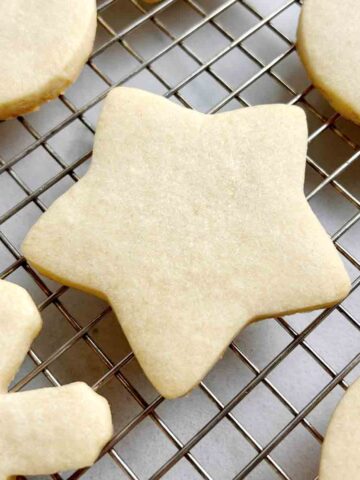 close up of star shaped sugar cookie on cookie rack.