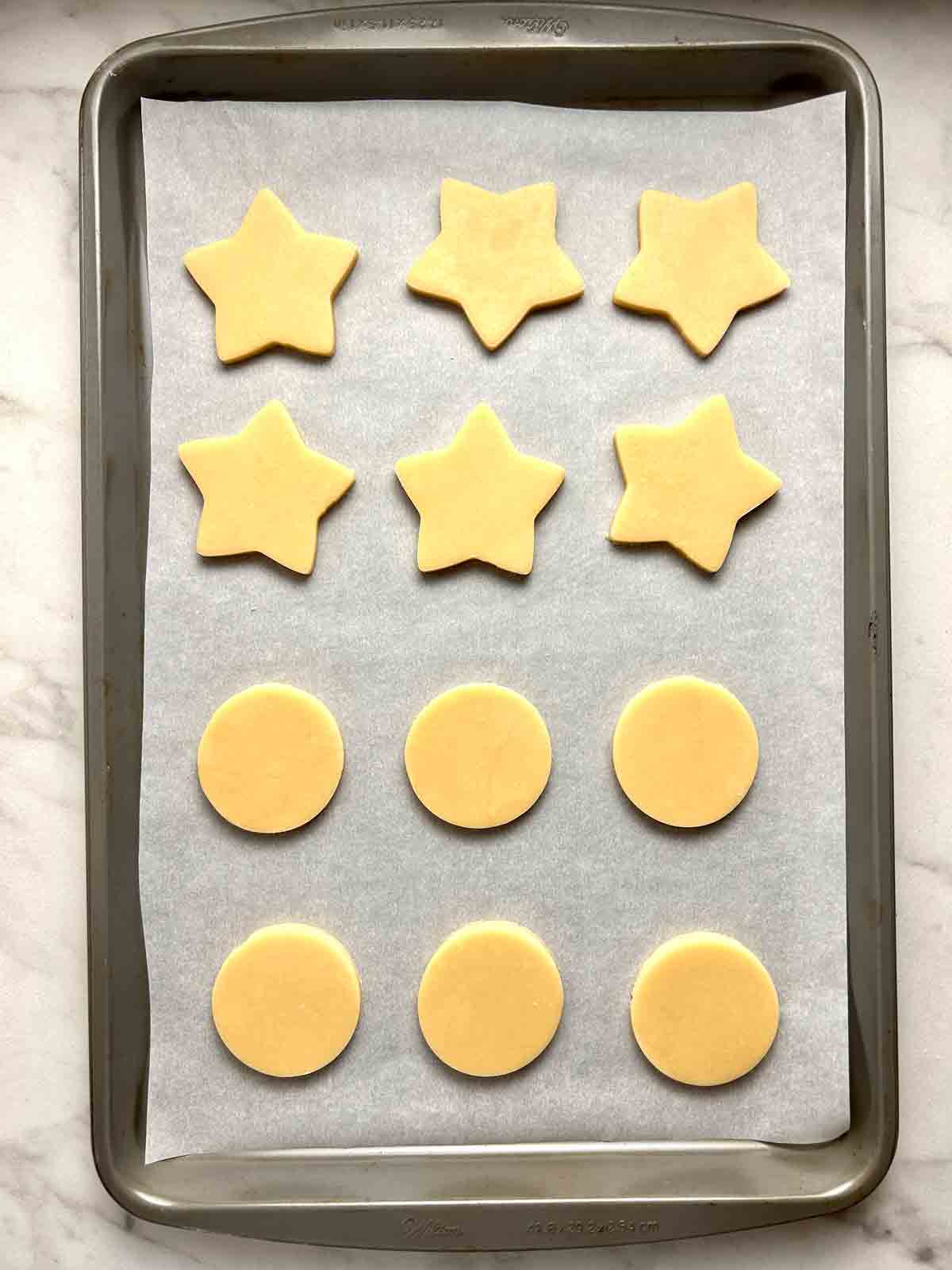 cut out cookie dough on baking sheet.