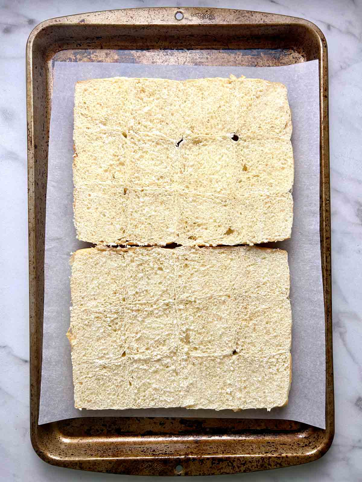 buns cut in half and placed on baking sheet.