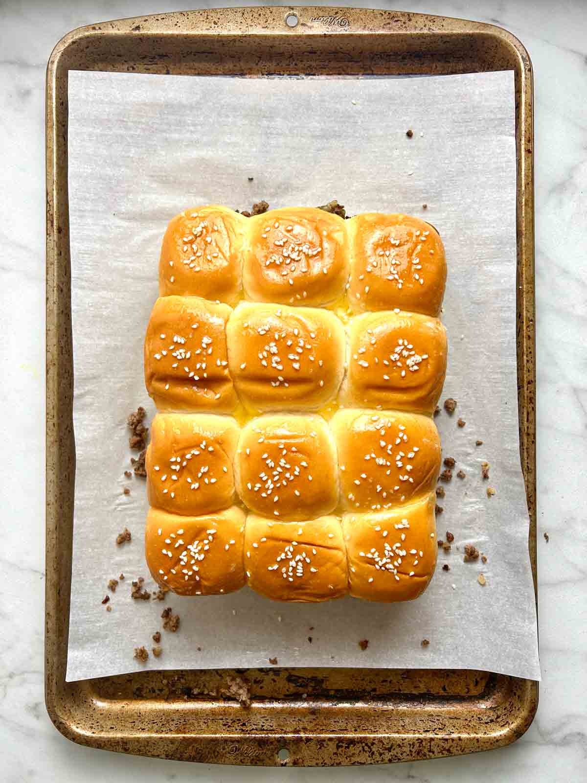 butter and sesame seeds on top of buns.