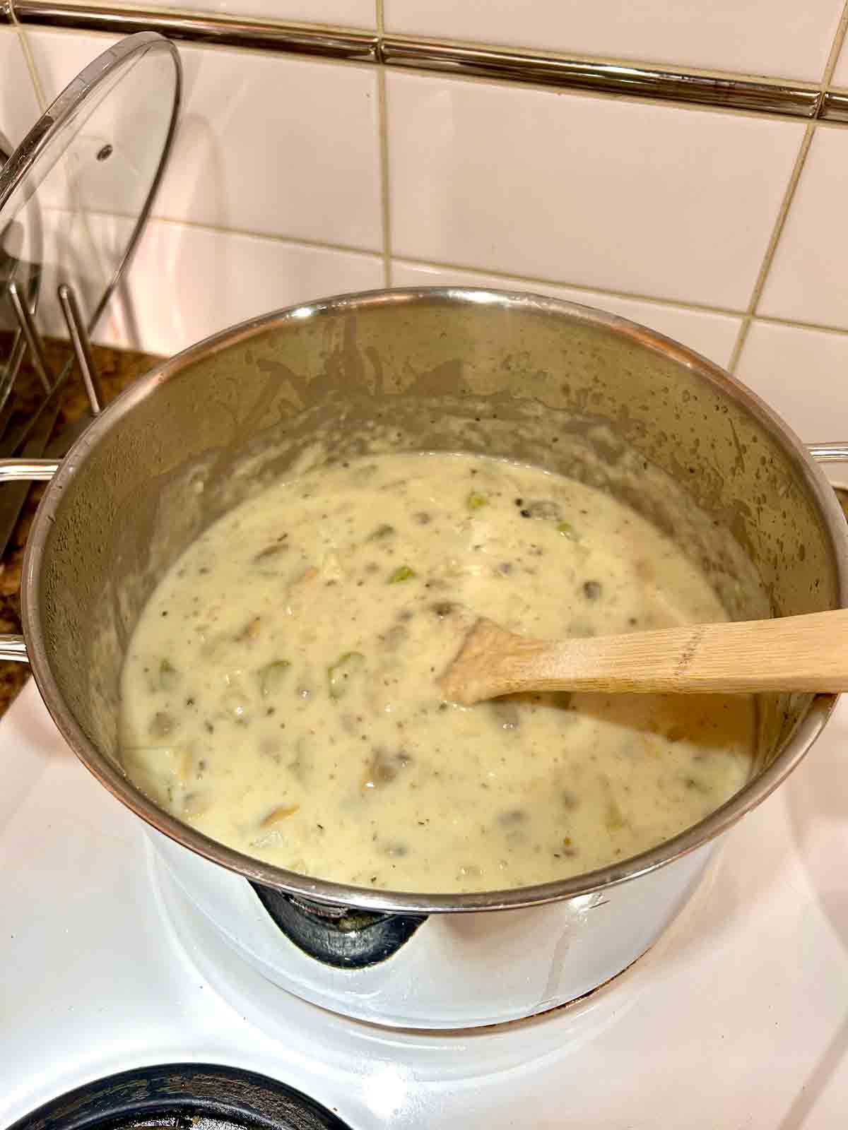 clam meat and cream stirred into pot.