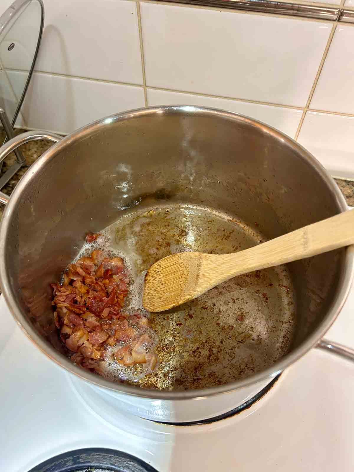 crisp bacon and leftover fat in pot.