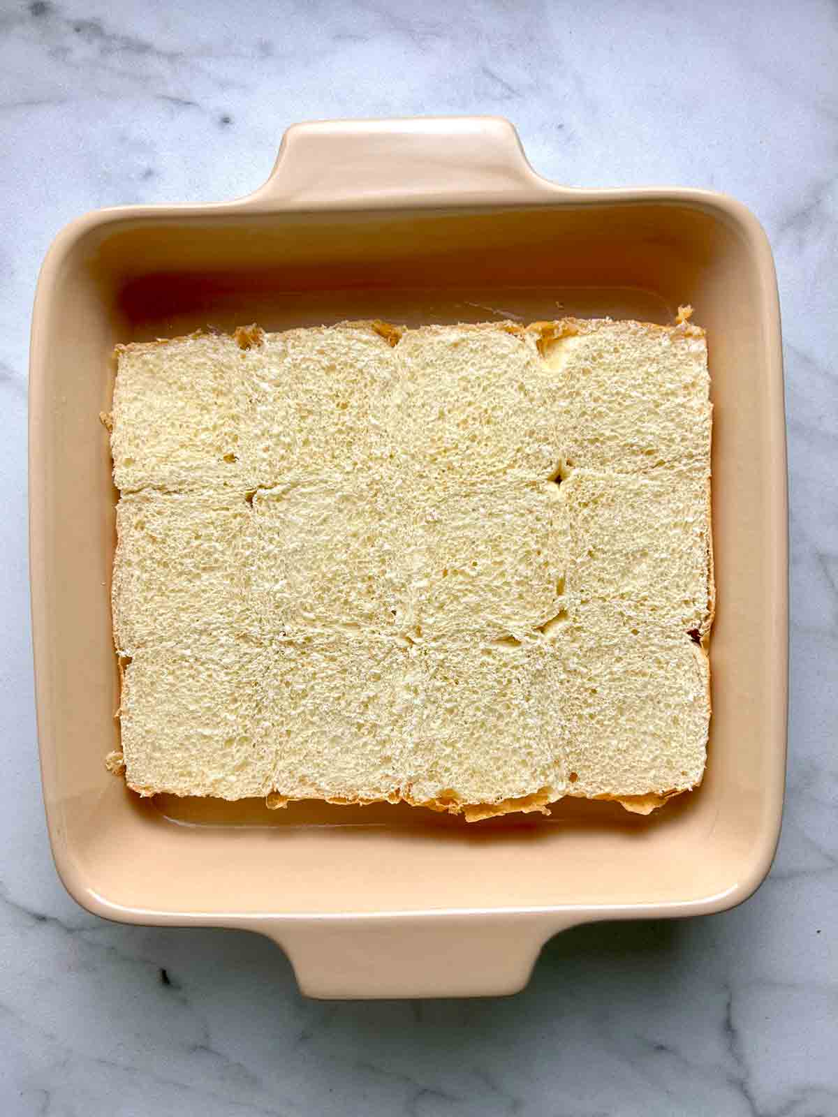 bottom half of rolls on baking dish.