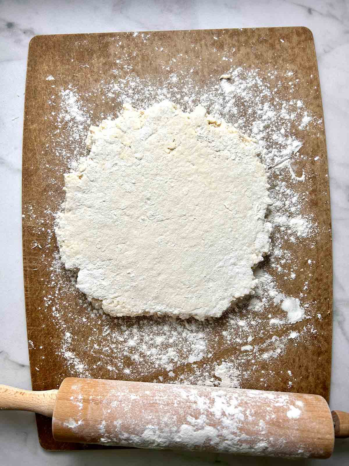 dough rolled out on cutting board.