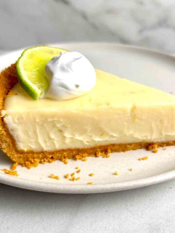 slice of key lime pie with cream on top.