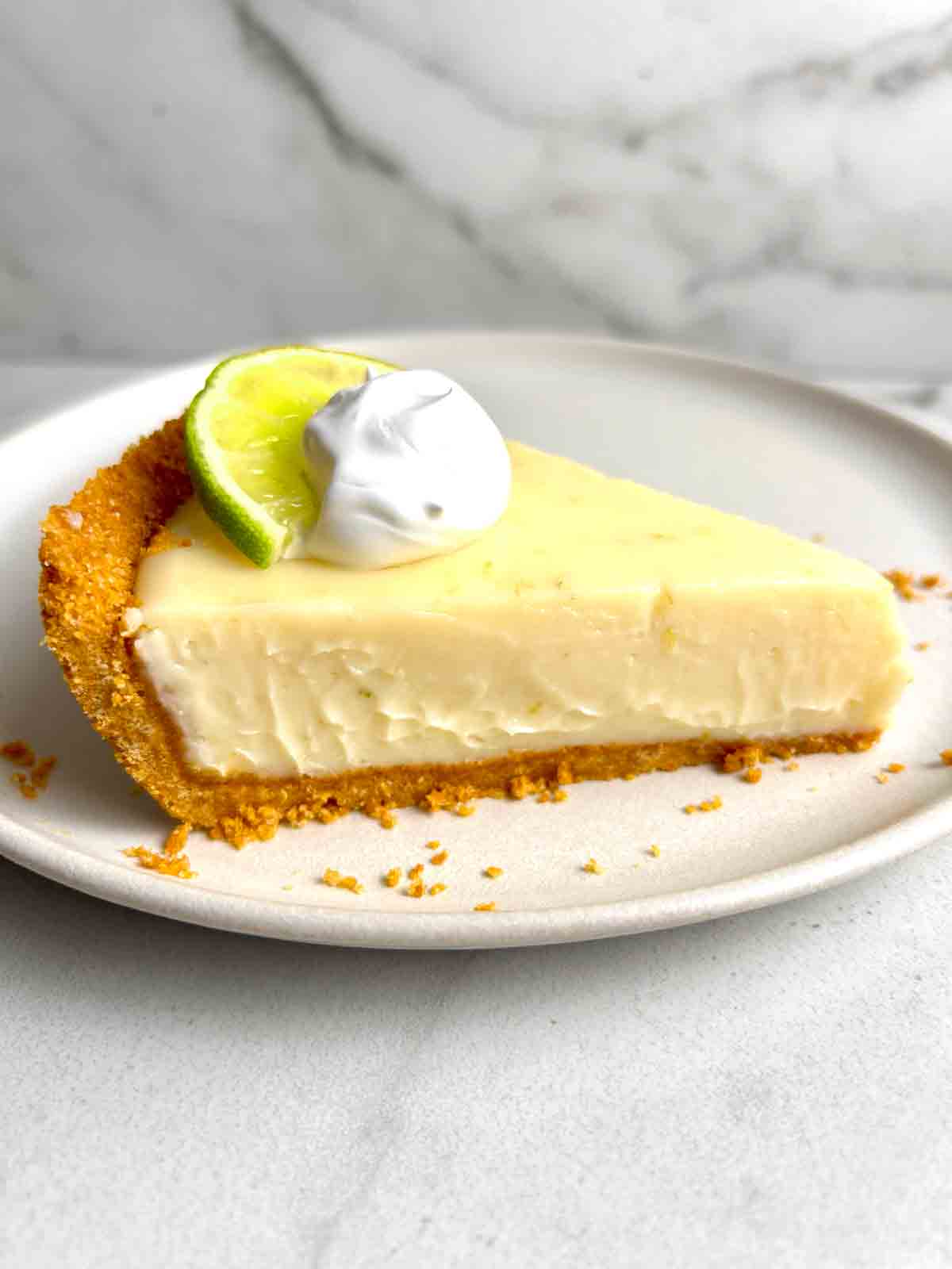slice of key lime pie with cream on top.