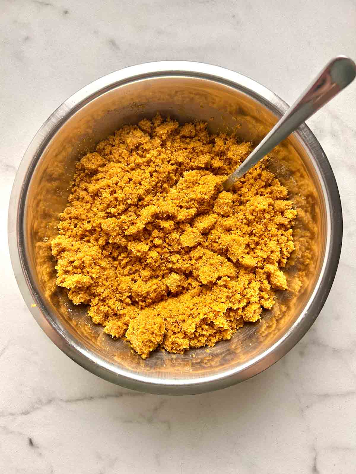 graham cracker crust being mixed together in bowl.