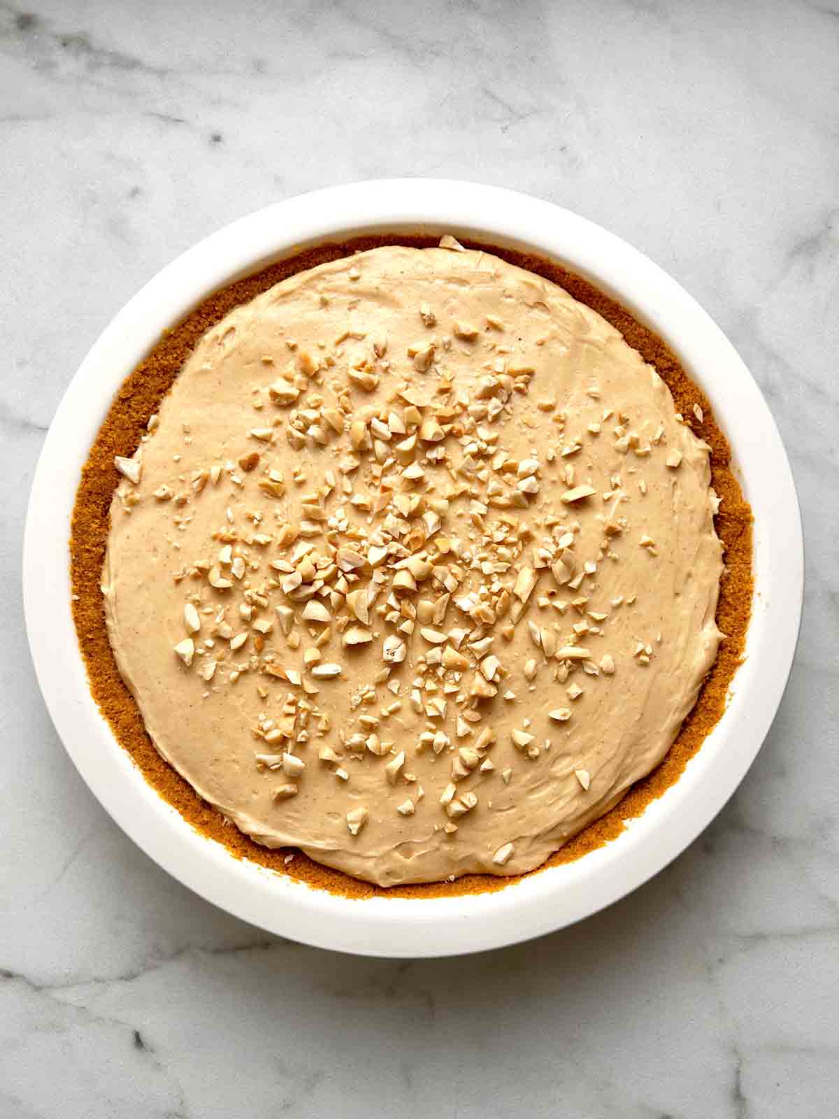 filling poured into pie crust and chopped peanuts sprinkled on top.