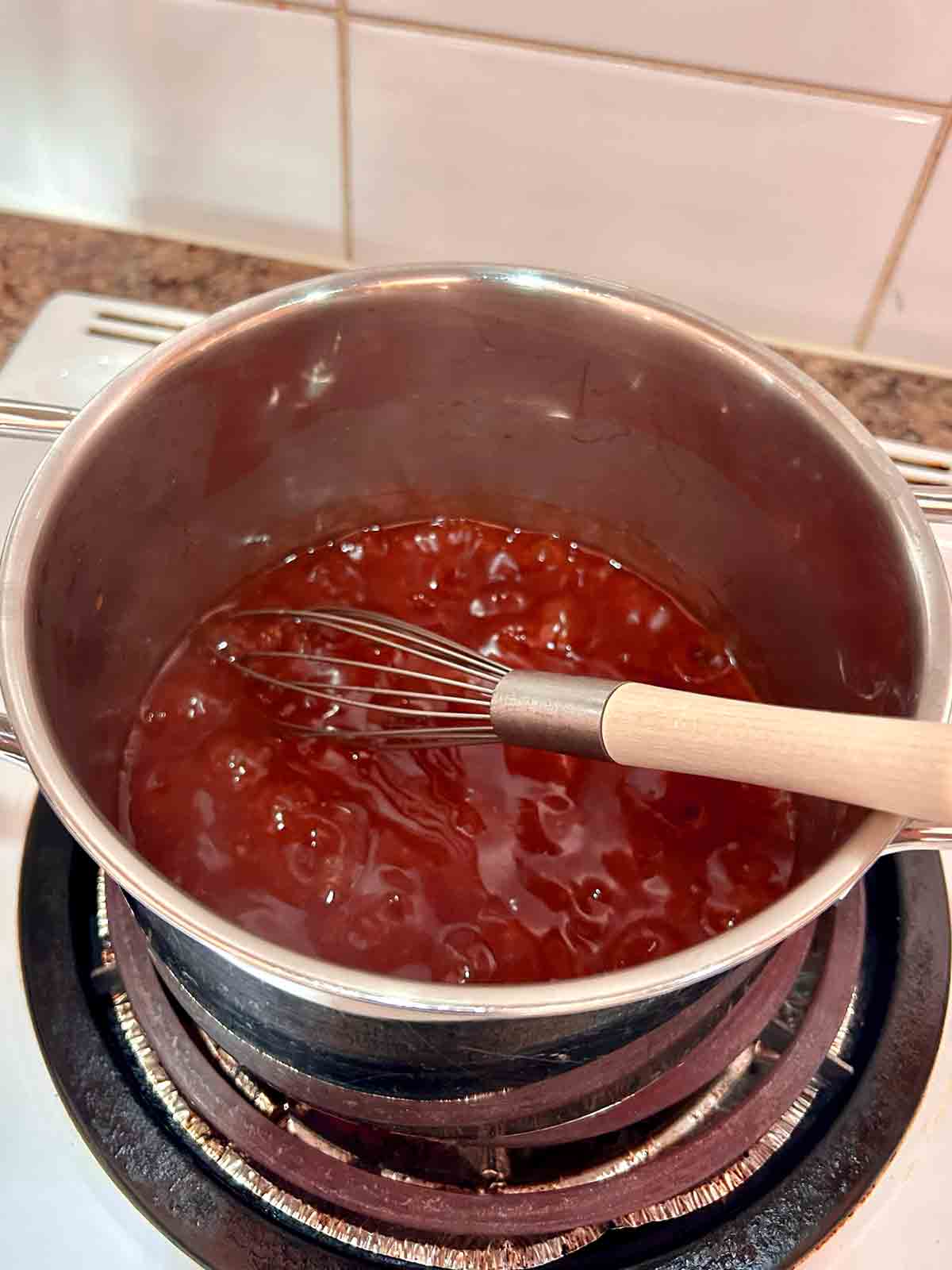 sauce simmering in saucepan.