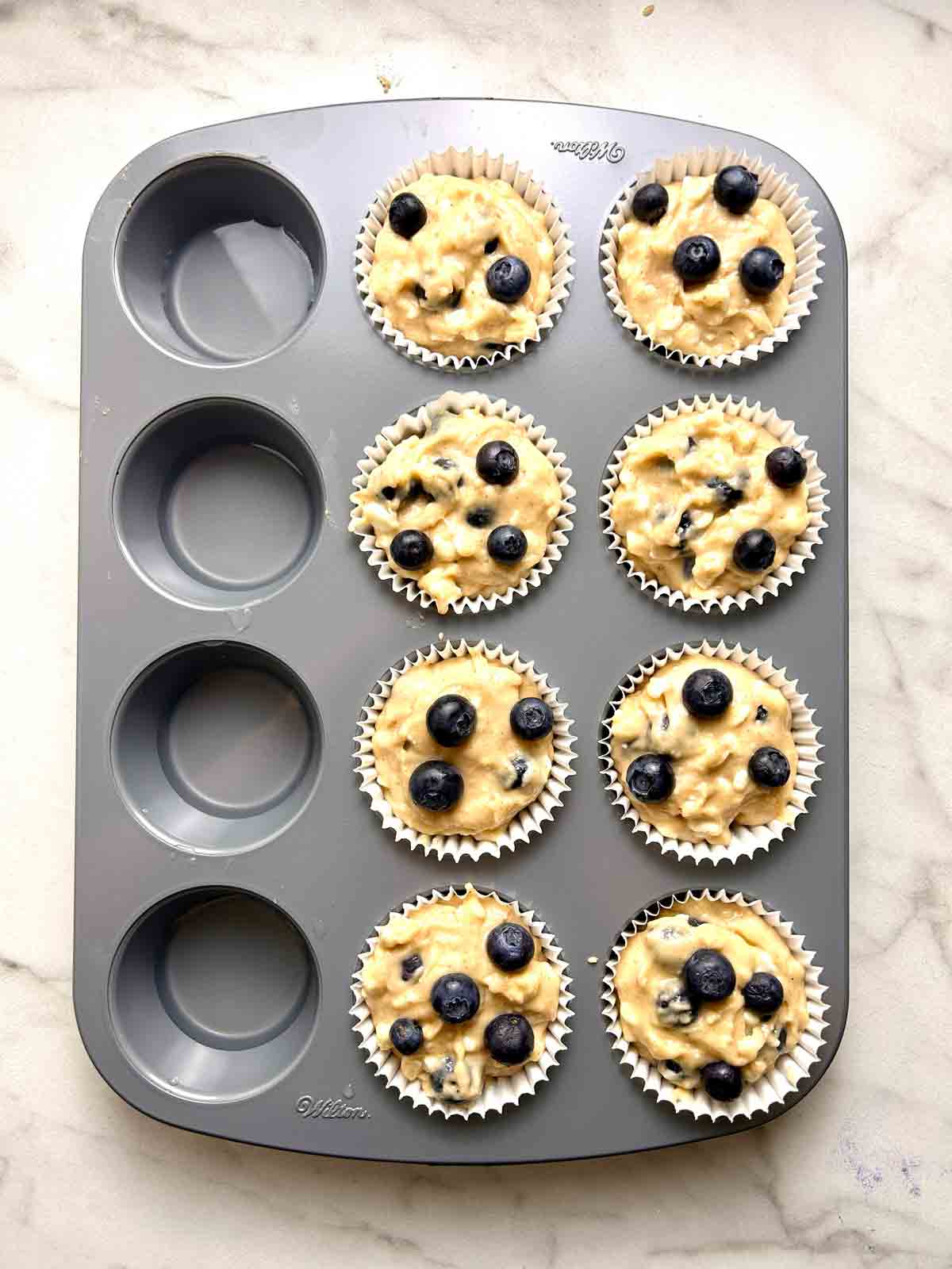 batter scooped into muffin liners.