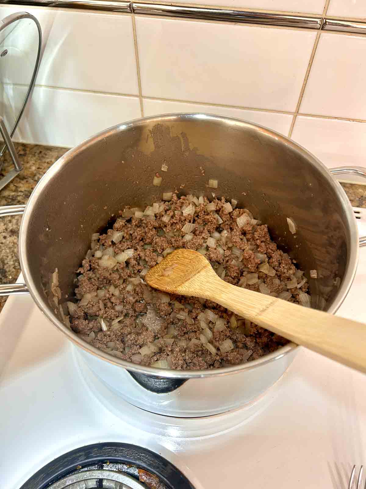 ground beef and onions cooked in pot.