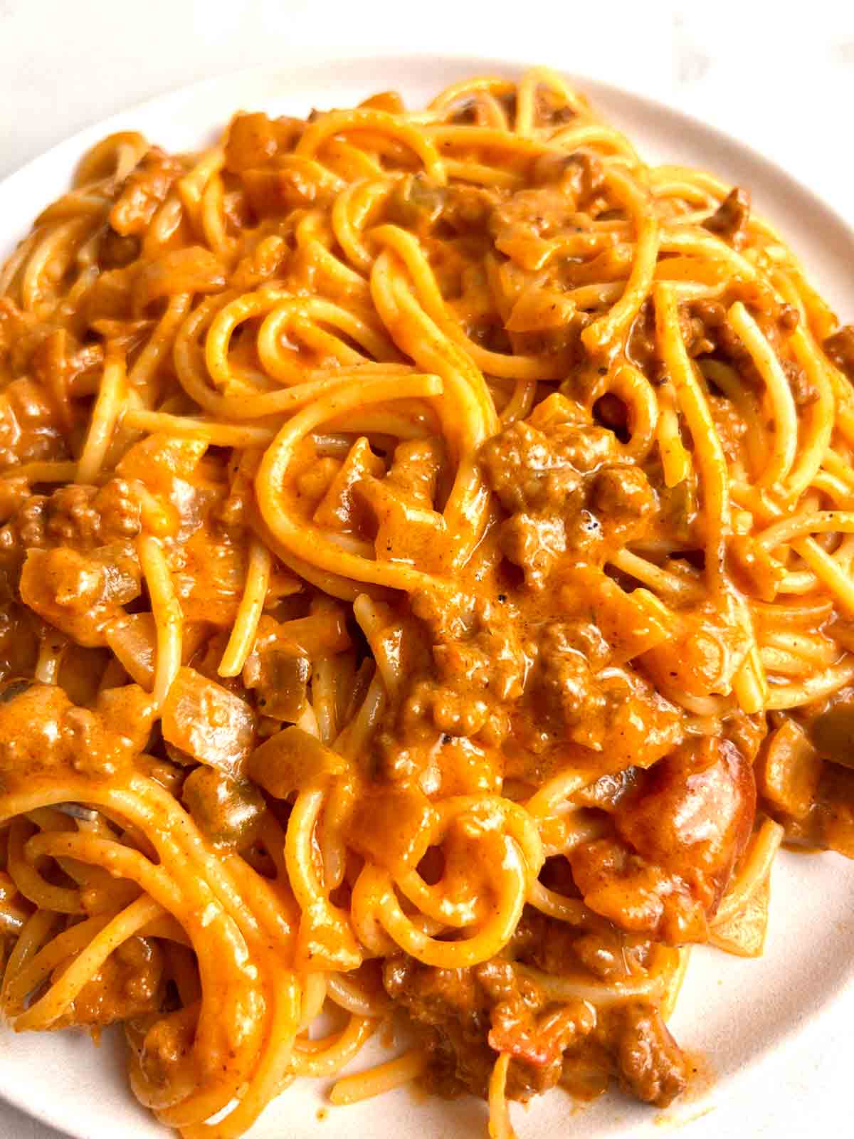 close up of cheesy taco spaghetti on plate.