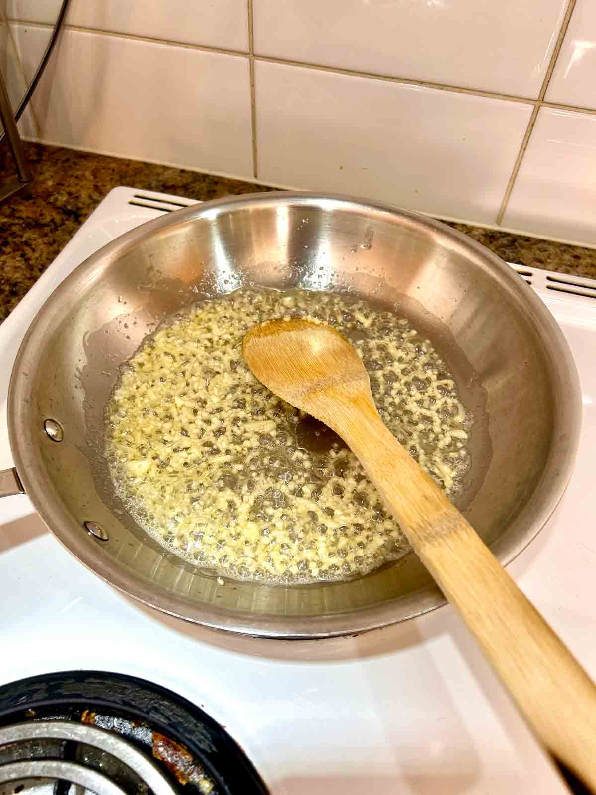 garlic being cooked in butter.