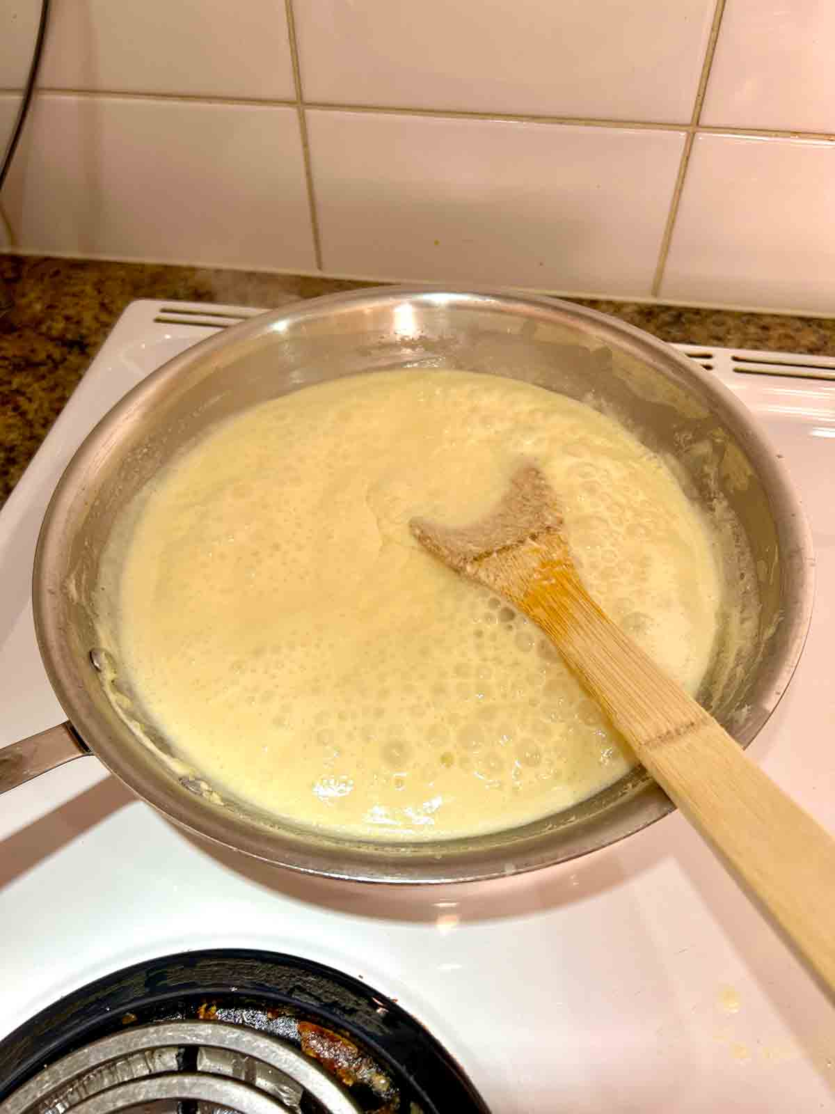 sauce being reduced in pan.