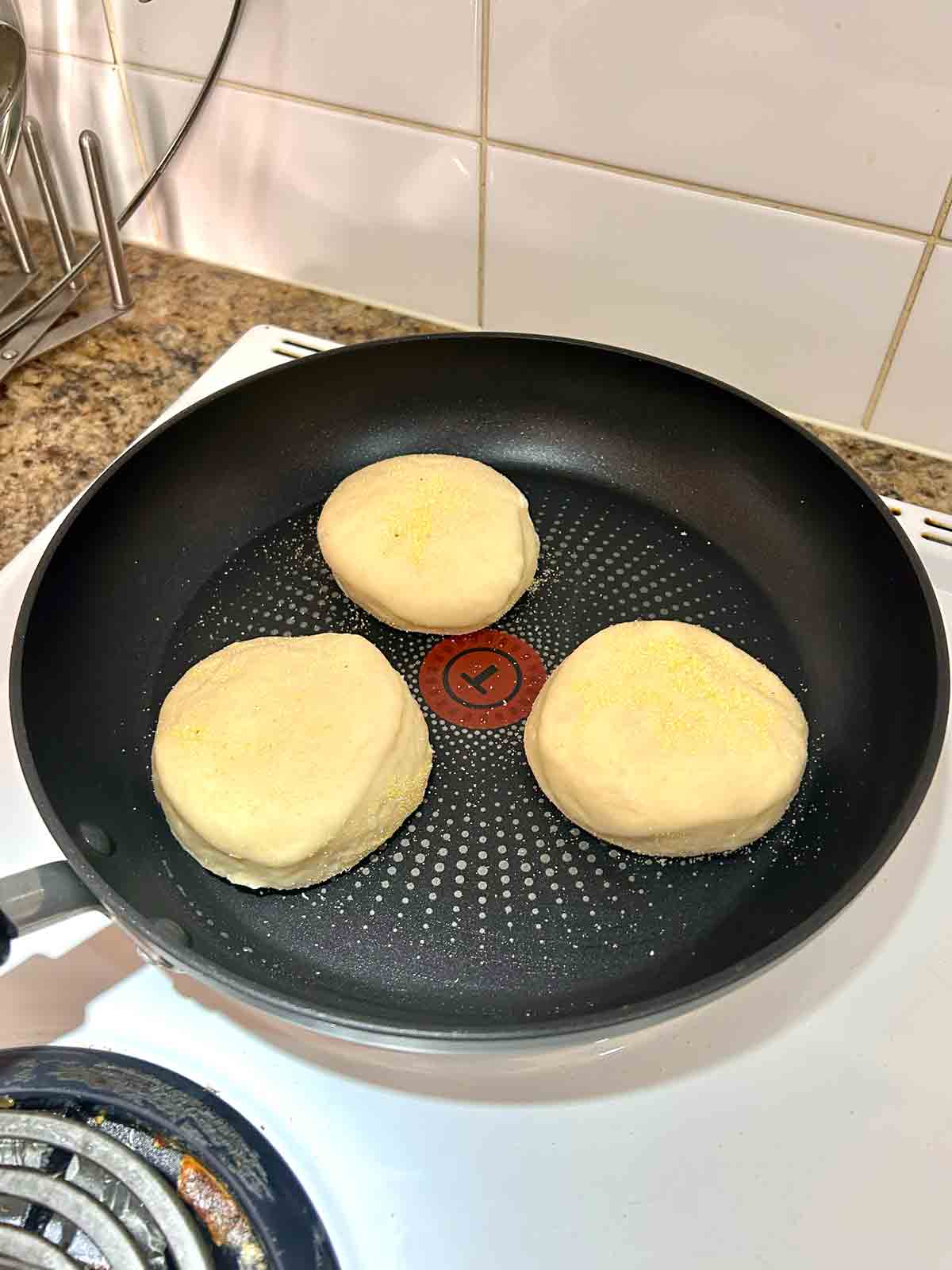English muffins cooked on skillet.