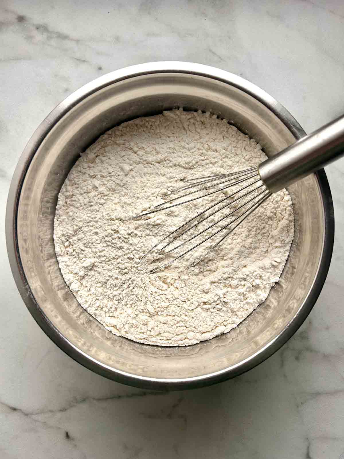 pancake mix ingredients whisked in bowl.