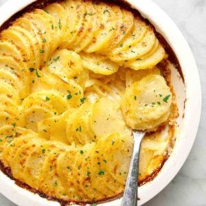 close up of potatoes au gratin in baking dish.