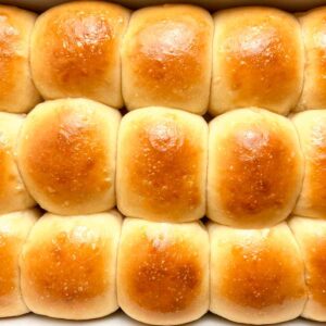 close up of sourdough dinner rolls in baking dish.