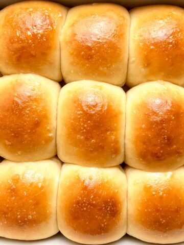 close up of sourdough dinner rolls in baking dish.