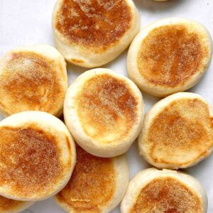 English muffins scattered on parchment paper.