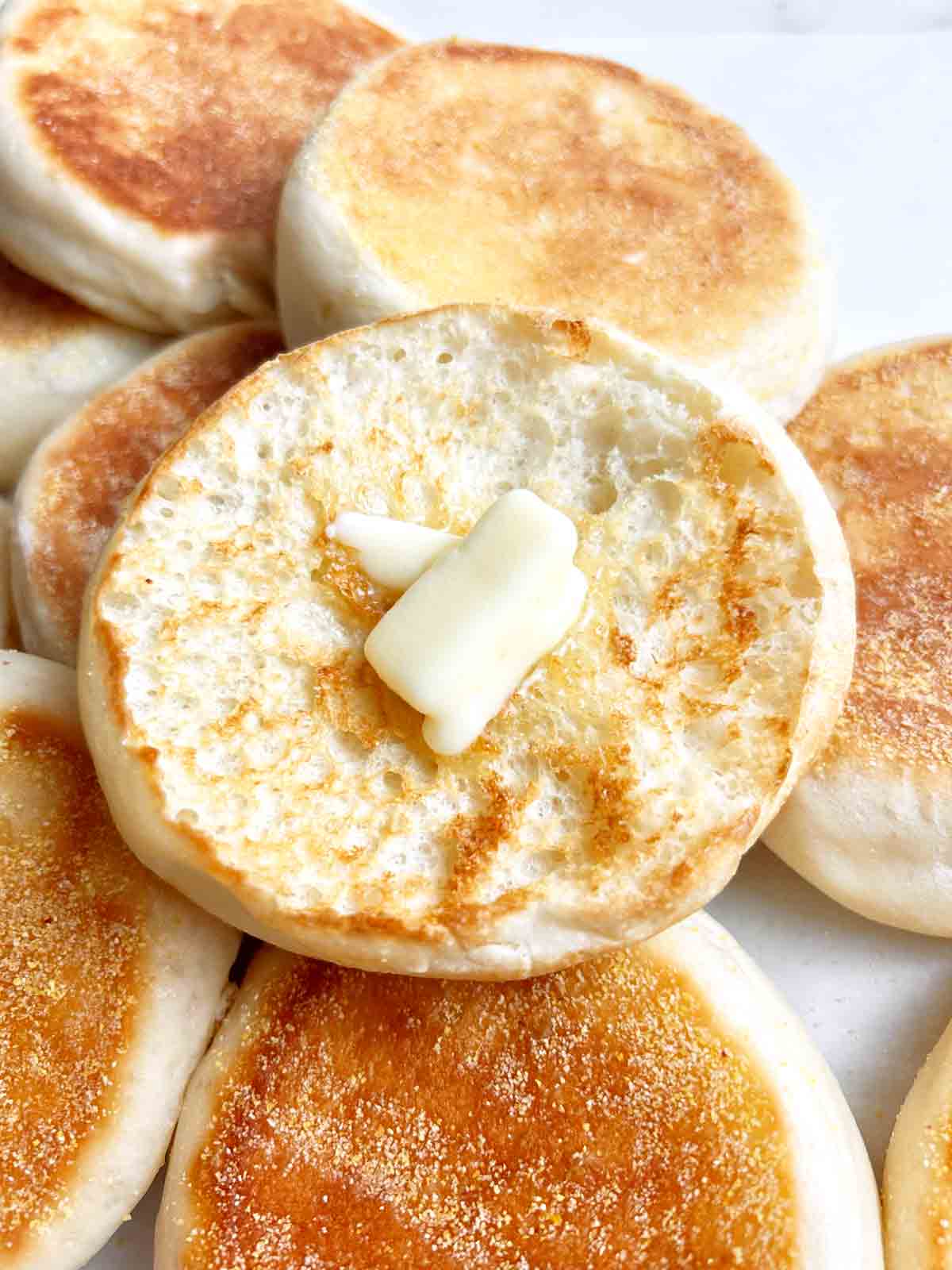 half of English muffin toasted with butter on it.