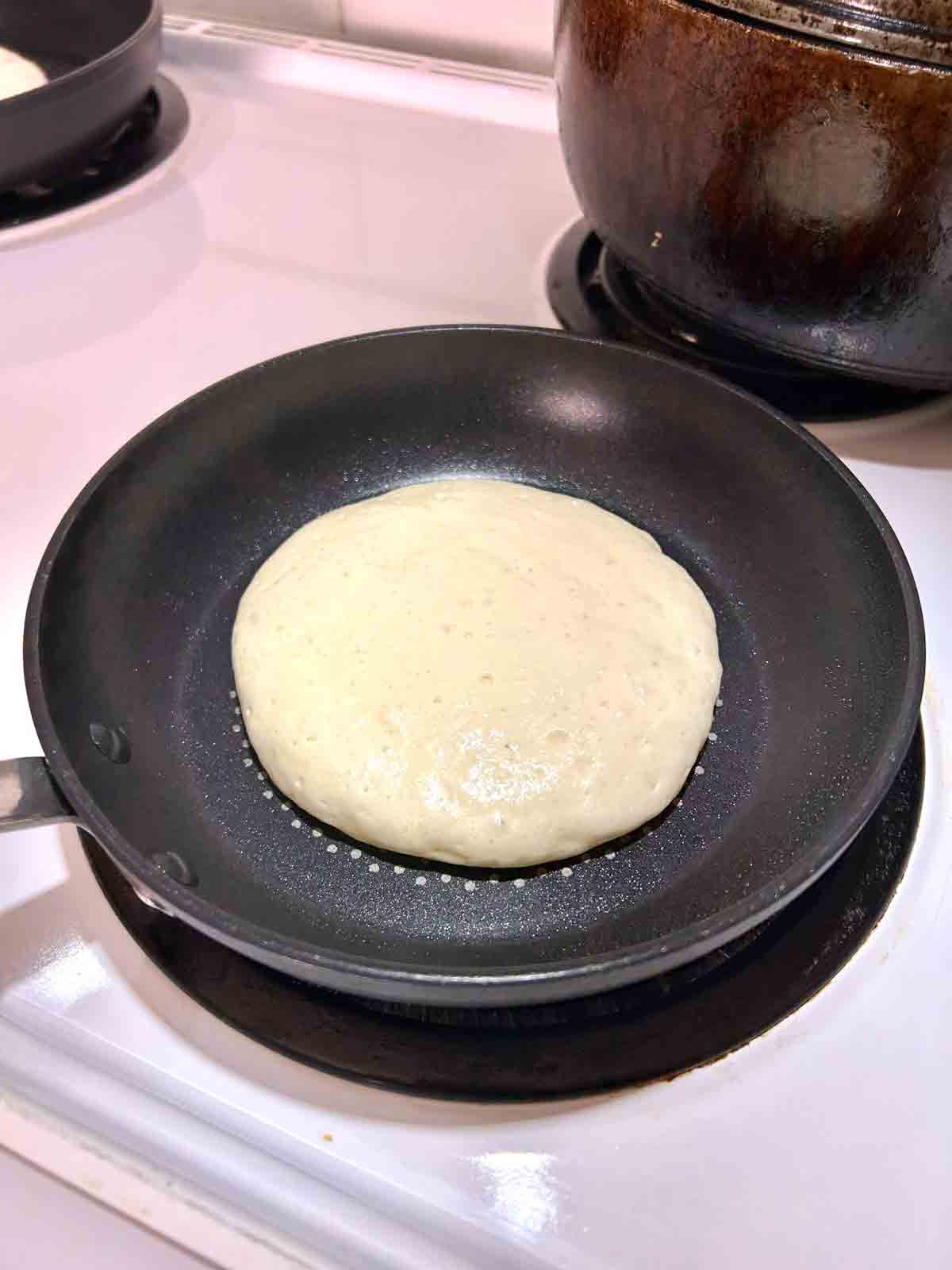 pancake batter cooking in pan.