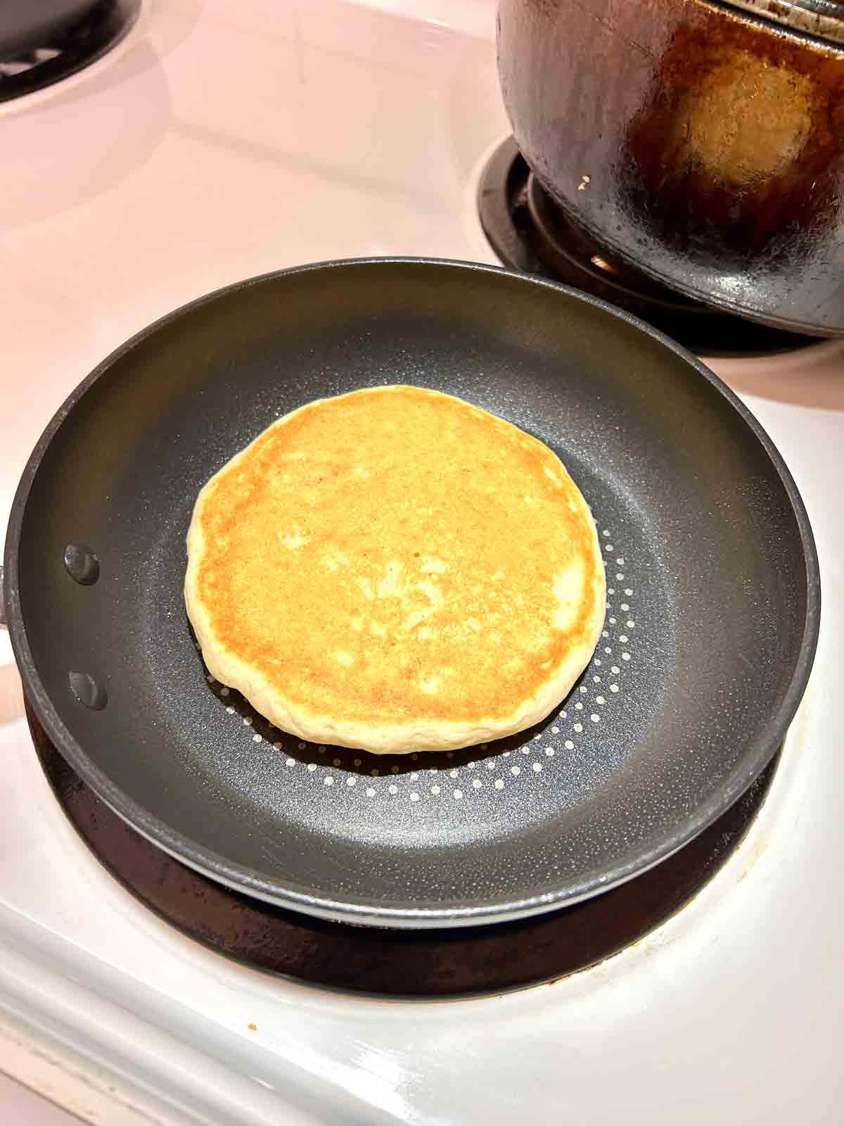 pancake flipped over to show golden brown side.