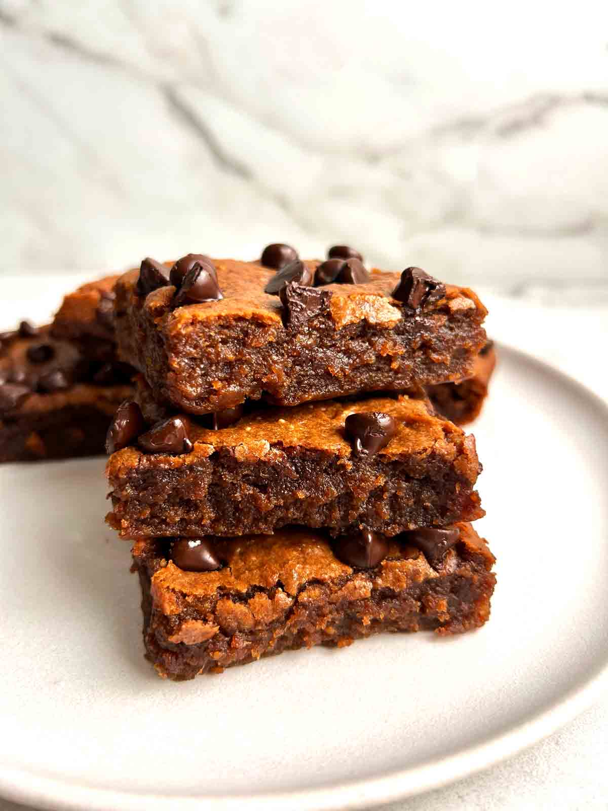 stack of sliced sweet potato brownies on plate.