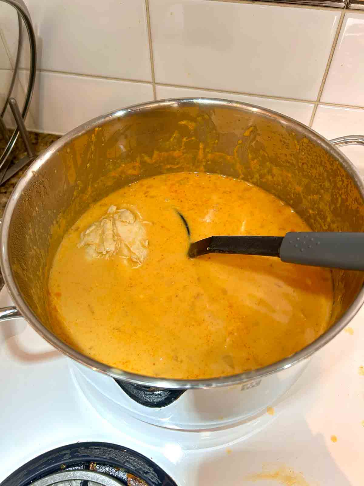 chicken, coconut milk, and broth added to pot.