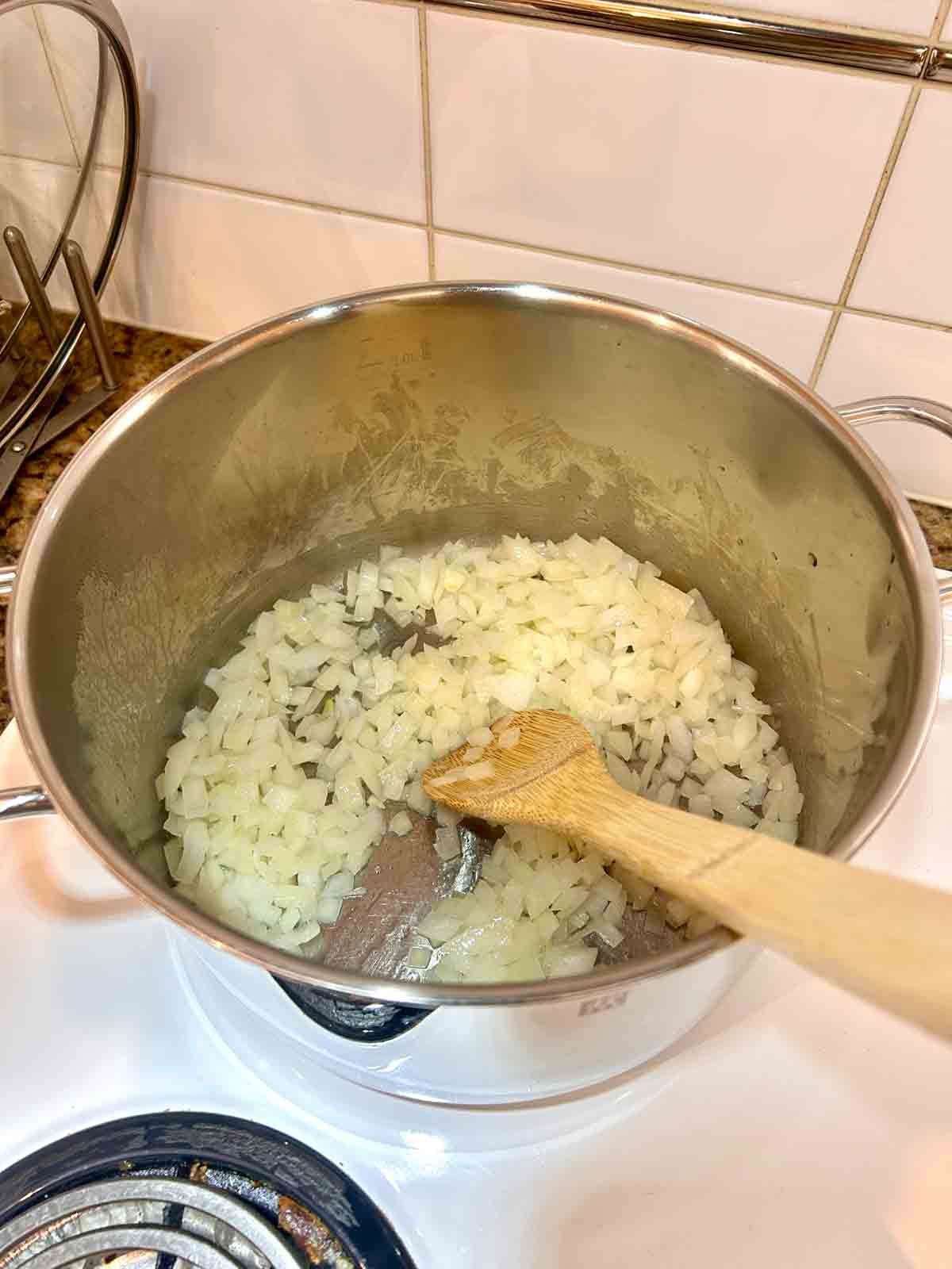 onions being sauteed in pot.