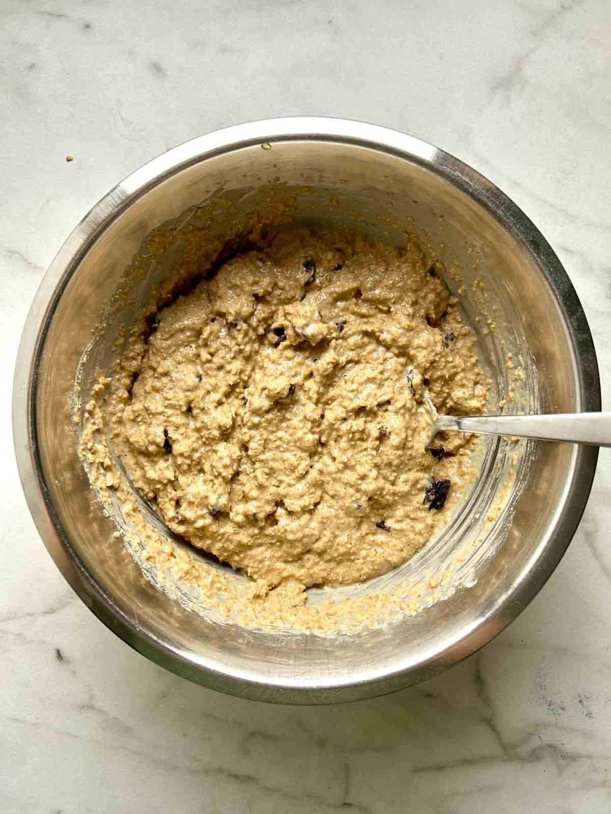 batter mixed in bowl with raisins folded in.