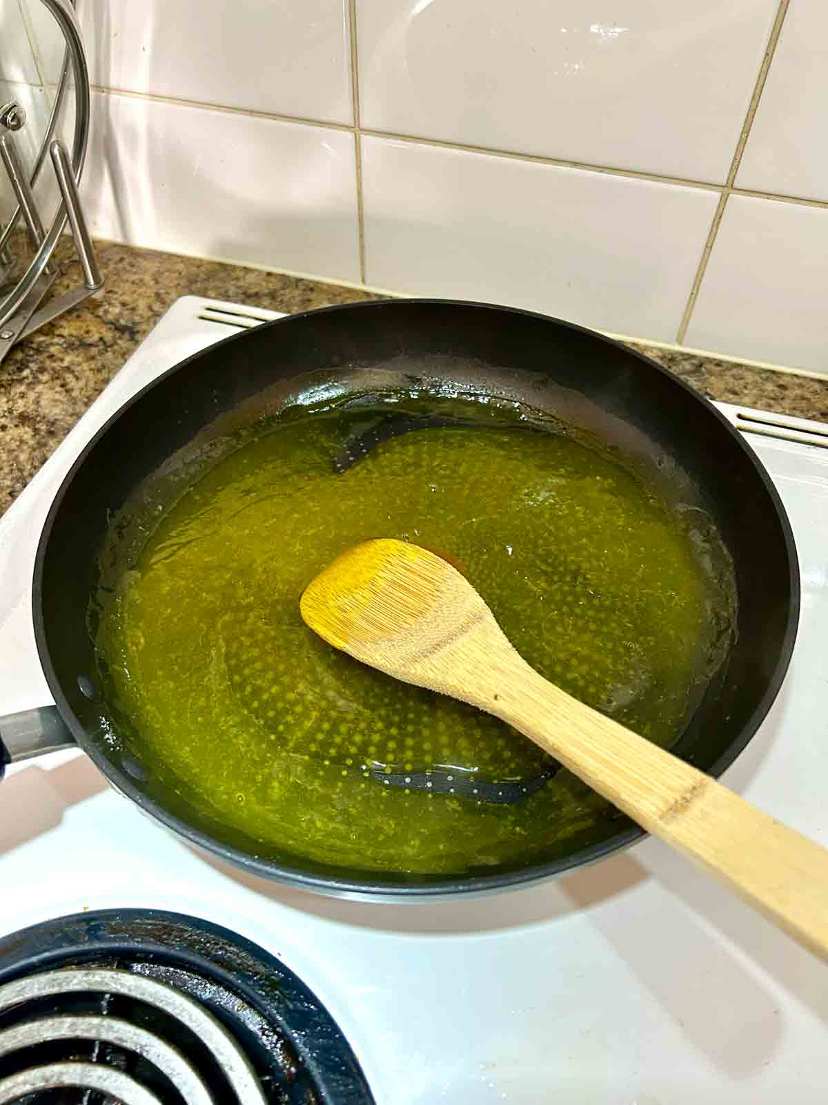lemon sauce being thickened in large pan.
