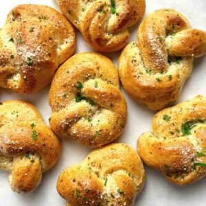 garlic knots on parchment paper.