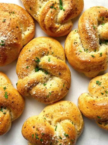garlic knots on parchment paper.