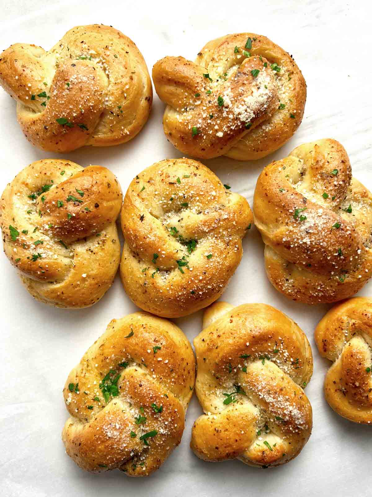garlic knots on parchment paper.